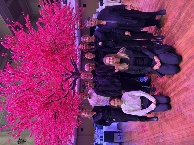 Exalt Strings musicians in front of a pink blossom tree